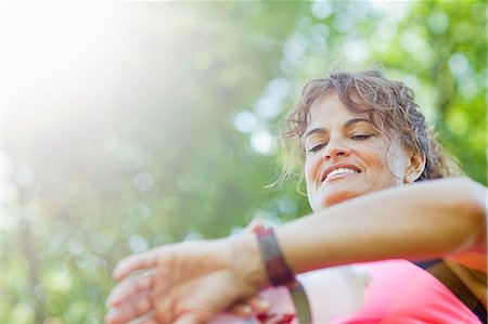 Woman checking watch during exercise Stock Photo - Premium Royalty-Free, Code: 6122-07697415