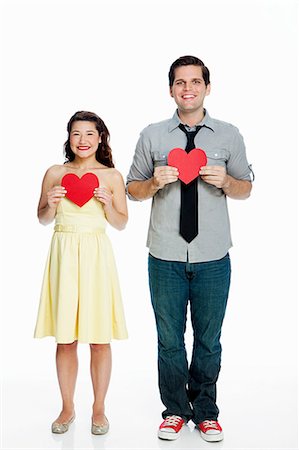 simsearch:614-06896896,k - Young couple holding heart shapes against white background Foto de stock - Sin royalties Premium, Código: 6122-07697431