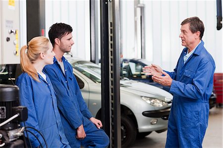 Mechanic talking with apprentices Stock Photo - Premium Royalty-Free, Code: 6122-07697592