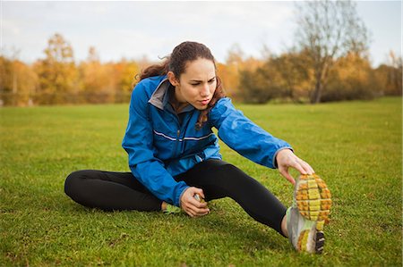 stretching (people exercising) - Young woman performing stretches in park Stock Photo - Premium Royalty-Free, Code: 6122-07697743