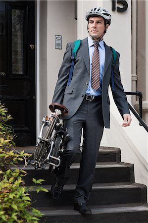 simsearch:614-02679462,k - Mid adult businessman carrying folding bicycle down steps Stock Photo - Premium Royalty-Free, Code: 6122-07697783