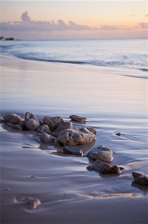 Caribbean sea washing over beach and rocks, Grand Cayman, Cayman Islands Stock Photo - Premium Royalty-Free, Code: 6122-07697989