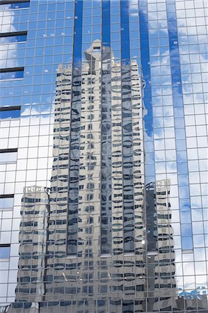 simsearch:6122-07697923,k - Building reflected in glass of skyscraper Stock Photo - Premium Royalty-Free, Code: 6122-07697923