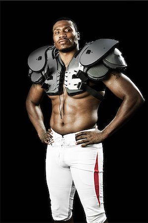 portrait of football player - American football player wearing shoulder padding Stock Photo - Premium Royalty-Free, Code: 6122-07698066