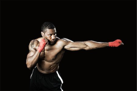 Boxer punching Foto de stock - Sin royalties Premium, Código: 6122-07698078