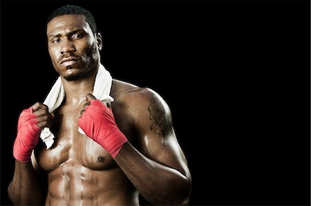 portrait african american serious male - Boxer with towel around neck Stock Photo - Premium Royalty-Free, Code: 6122-07698079