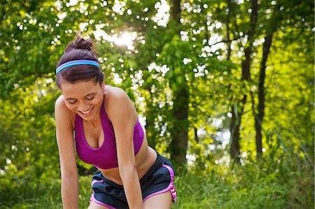 Young woman bending forwards Stock Photo - Premium Royalty-Free, Code: 6122-07698273