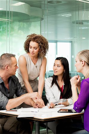 Office colleagues discussing new technologies on desk Stock Photo - Premium Royalty-Free, Code: 6122-07698372