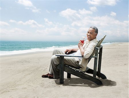 Mature man relaxing in chair on beach Stock Photo - Premium Royalty-Free, Code: 6122-07698320