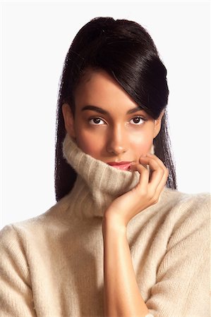 simsearch:614-06898098,k - Young woman wearing polo neck against white background Foto de stock - Royalty Free Premium, Número: 6122-07698472