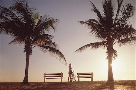 simsearch:649-08232809,k - Woman standing with bicycle by palm trees Stock Photo - Premium Royalty-Free, Code: 6122-07698527