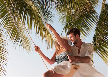 swinging summer adult - Couple playing on swing Stock Photo - Premium Royalty-Free, Code: 6122-07699011