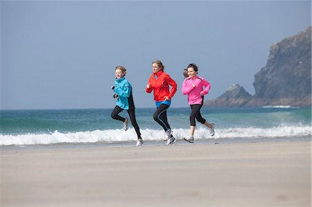 running teenage boy & girl - Family running together on beach Stock Photo - Premium Royalty-Free, Code: 6122-07699276