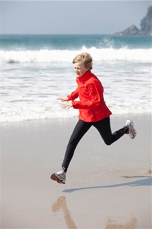 freedom teen blond beach - Boy running on beach Stock Photo - Premium Royalty-Free, Code: 6122-07699285