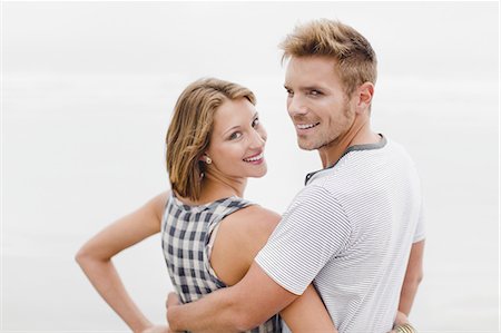 simsearch:649-03882343,k - Smiling couple hugging on beach Stock Photo - Premium Royalty-Free, Code: 6122-07699394