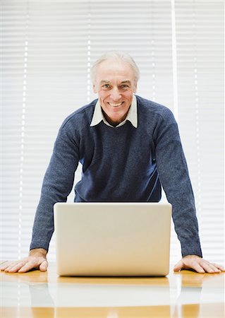 simsearch:649-03797576,k - Businessman at laptop in office Stock Photo - Premium Royalty-Free, Code: 6122-07699414