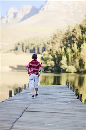 Boy walking fishing pole summer hi-res stock photography and