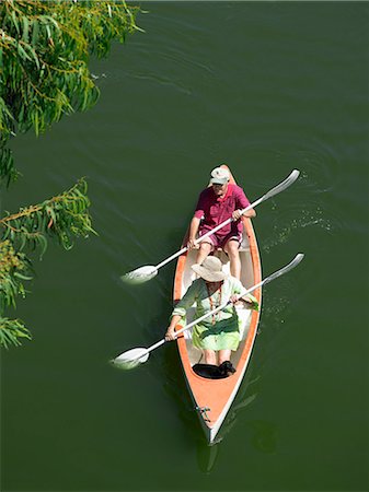 sitting aerial view - Older couple rowing canoe on lake Stock Photo - Premium Royalty-Free, Code: 6122-07699793