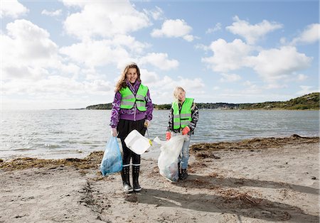 people cleaning sea - Girls in safety vests cleaning beach Stock Photo - Premium Royalty-Free, Code: 6122-07699886