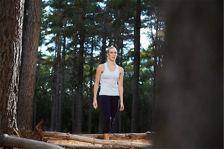 simsearch:6122-07705141,k - Woman walking in forest Stock Photo - Premium Royalty-Free, Code: 6122-07700496