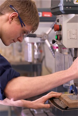 Worker using saw in factory Stock Photo - Premium Royalty-Free, Code: 6122-07700650