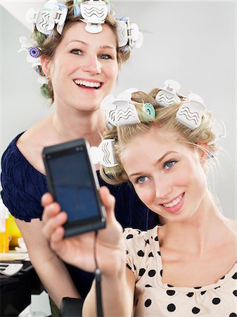 simsearch:6122-07704333,k - Women photographing themselves in salon Stock Photo - Premium Royalty-Free, Code: 6122-07700712