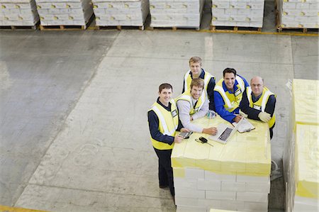 Workers using laptop in warehouse Stock Photo - Premium Royalty-Free, Code: 6122-07700918