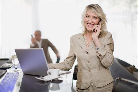 simsearch:649-03882419,k - Businesswoman on phone using laptop Stock Photo - Premium Royalty-Free, Code: 6122-07701542