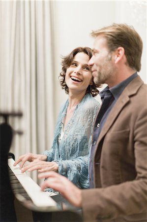 piano pictures of women - Couple playing piano together at home Stock Photo - Premium Royalty-Free, Code: 6122-07701646