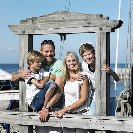 family traveling with teens - Family smiling together on pier Stock Photo - Premium Royalty-Free, Code: 6122-07701780