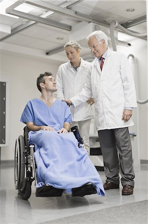 simsearch:6113-07905882,k - Doctors talking to patient in wheelchair Stock Photo - Premium Royalty-Free, Code: 6122-07701701