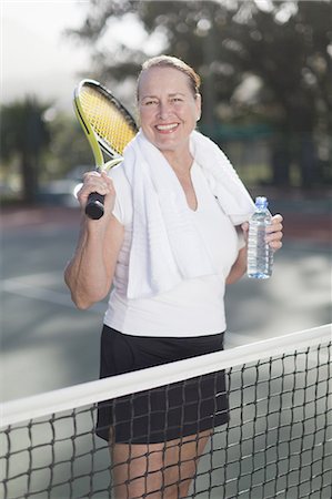 Older woman standing on tennis court Stock Photo - Premium Royalty-Free, Code: 6122-07702105