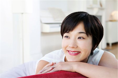 simsearch:614-07145856,k - Smiling woman relaxing on sofa Stock Photo - Premium Royalty-Free, Code: 6122-07702134