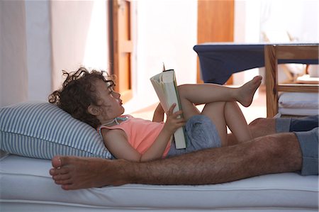 simsearch:649-03667137,k - Girl reading with father on sofa Foto de stock - Royalty Free Premium, Número: 6122-07702392