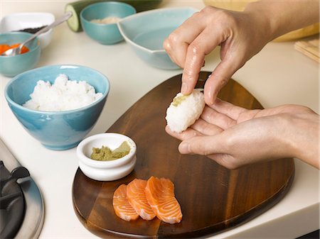 seafood festival - Woman preparing sushi at table Stock Photo - Premium Royalty-Free, Code: 6122-07702988