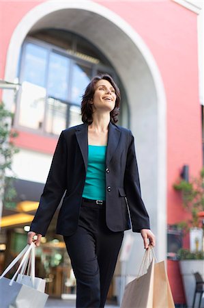 retail business on the go - Businesswoman carrying shopping bags Stock Photo - Premium Royalty-Free, Code: 6122-07703153