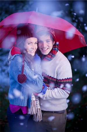 simsearch:6108-06908128,k - Smiling couple under umbrella in snow Stock Photo - Premium Royalty-Free, Code: 6122-07703277