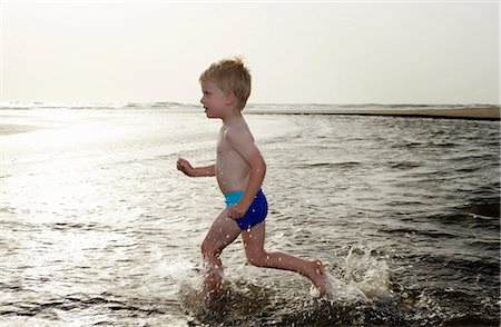 simsearch:6108-06904648,k - Boy playing in water at beach Stock Photo - Premium Royalty-Free, Code: 6122-07703288