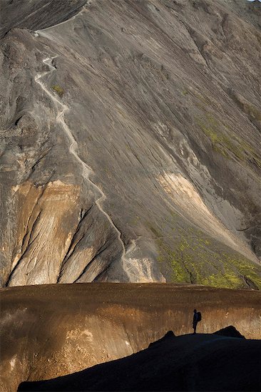 Man hiking in rocky rural landscape Stock Photo - Premium Royalty-Free, Image code: 6122-07703225