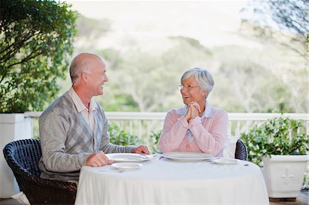 simsearch:6122-07703554,k - Older couple sitting at table outdoors Stock Photo - Premium Royalty-Free, Code: 6122-07703545