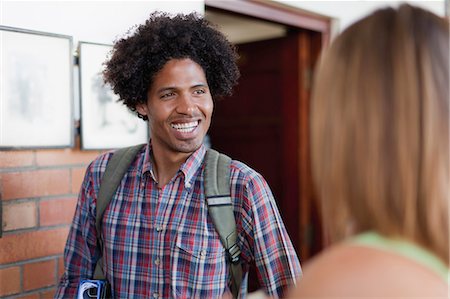 south africa and young adult and happy - Student smiling in hallway Stock Photo - Premium Royalty-Free, Code: 6122-07703578
