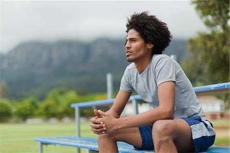 students sitting on bleachers - Man sitting on bleachers in park Stock Photo - Premium Royalty-Free, Code: 6122-07703618