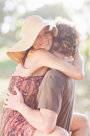 Smiling couple hugging in field Stock Photo - Premium Royalty-Free, Code: 6122-07703973