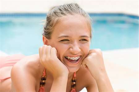 simsearch:6122-07703990,k - Teenage girl in braces relaxing by pool Stock Photo - Premium Royalty-Free, Code: 6122-07703983