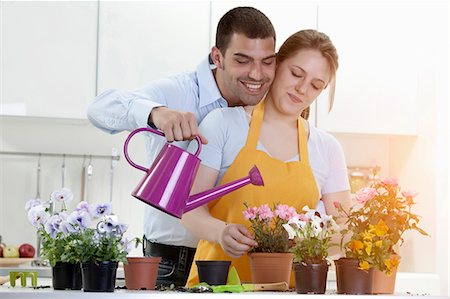 Couple watering potted plants indoors Fotografie stock - Premium Royalty-Free, Codice: 6122-07703918