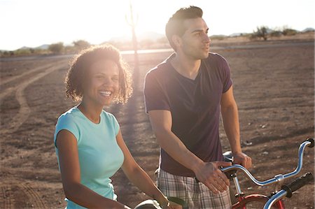 simsearch:6113-06908557,k - Couple with bicycles in desert landscape Stock Photo - Premium Royalty-Free, Code: 6122-07704084