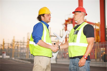 Construction workers talking on site Stock Photo - Premium Royalty-Free, Code: 6122-07704029