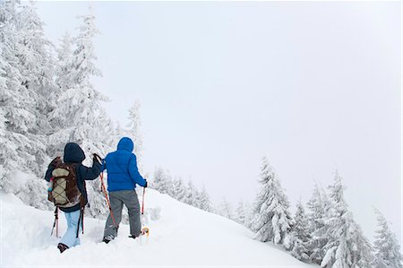 Father and son snowshoeing on hillside Stock Photo - Premium Royalty-Free, Code: 6122-07704256