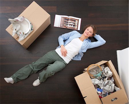Woman laying on floor with boxes Stock Photo - Premium Royalty-Free, Code: 6122-07704273