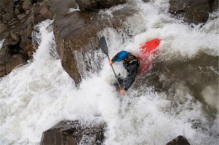 simsearch:6122-07692933,k - Man canoeing over rocky waterfall Photographie de stock - Premium Libres de Droits, Code: 6122-07704233